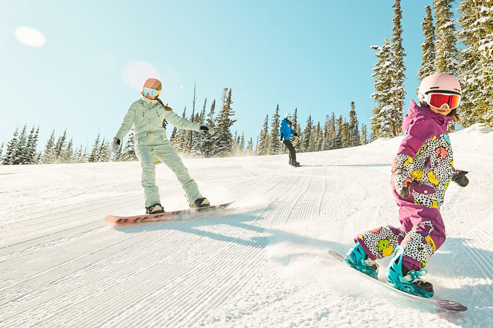 Girls snowboarding during a lesson at Keystone Resort