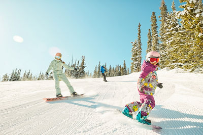 Girls snowboarding during a lesson at Keystone Resort