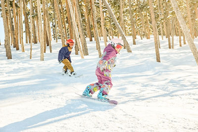 Two snowboarders in trees during a lesson at Keystone Resort