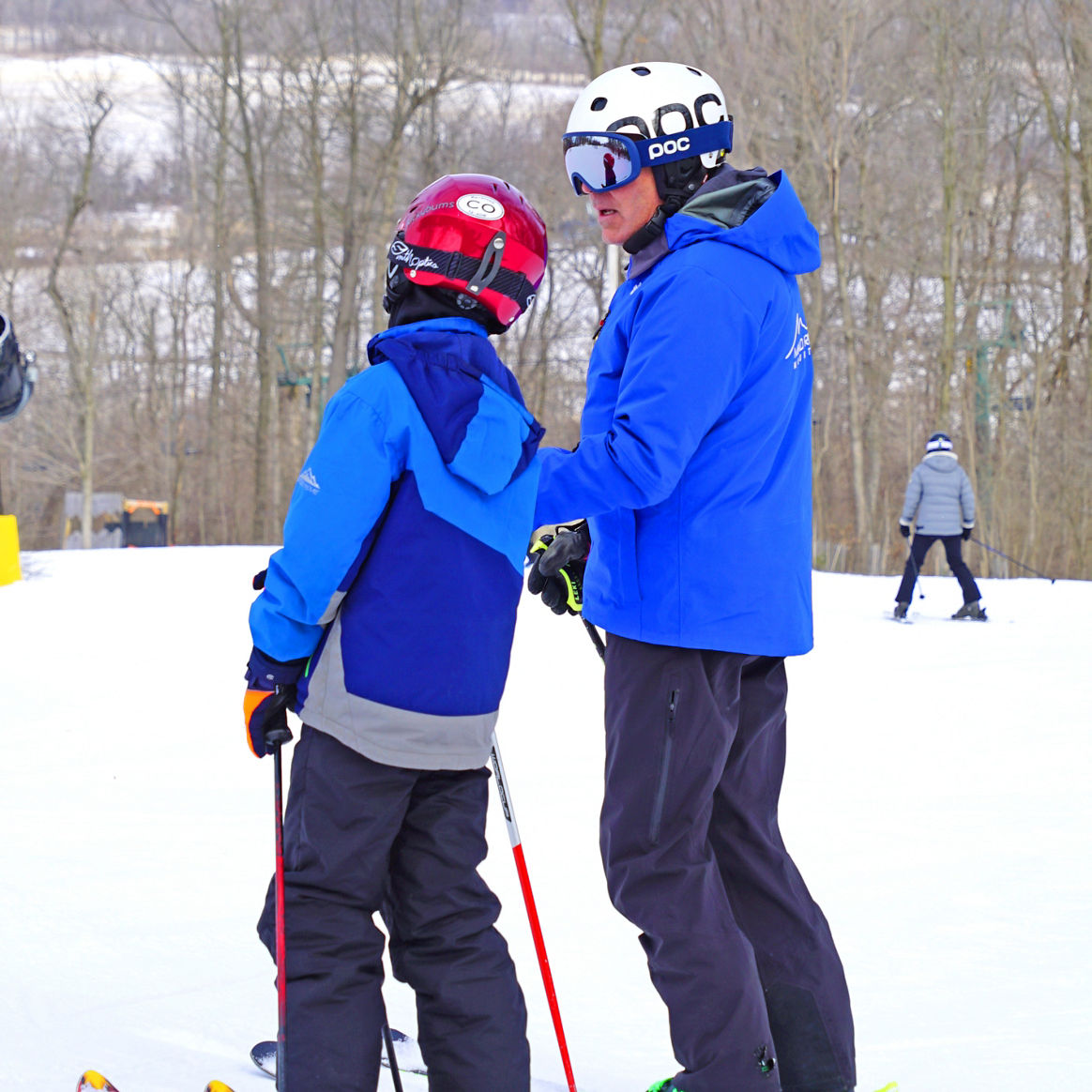 Ski Instructor Guides Little Boy in Lesson at Mad River Mountain