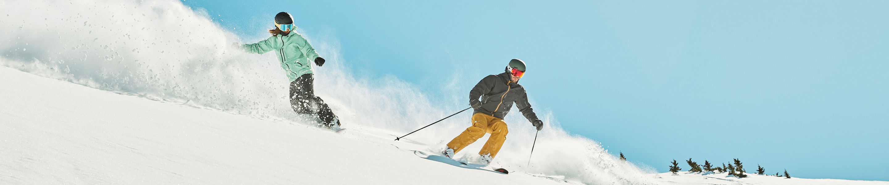 Skier and snowboarder ripping fresh snow at Keystone Resort