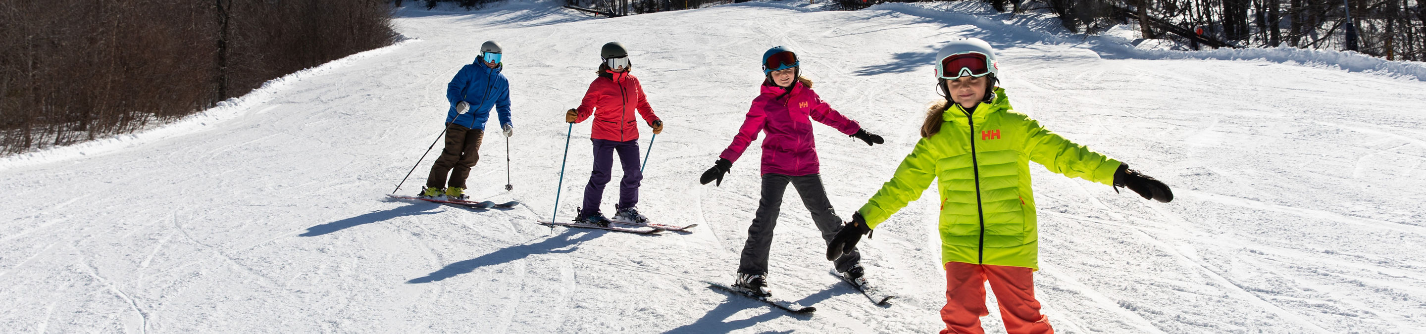 Two Parents Skiing with Two Children at Mount Sunapee