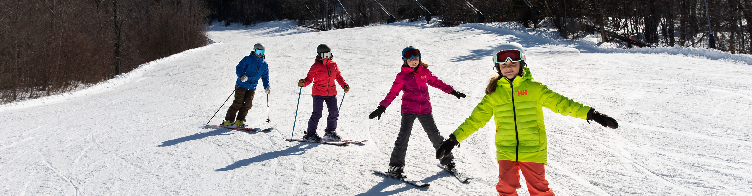 Two Parents Skiing with Two Children at Mount Sunapee