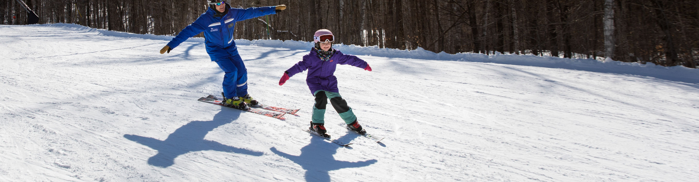 Girl Skiing with Instructor at Mount Sunapee