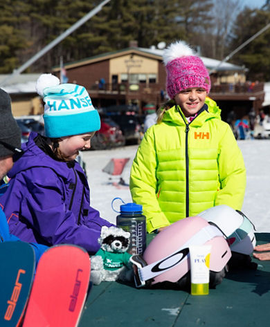 Family Relaxing at Picnic Table at Mount Sunapee