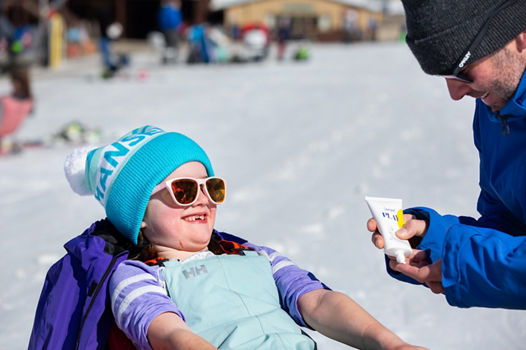 Dad Putting Sunscreen on Child's Nose at Mount Sunapee