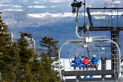 Adults Riding Lift with Instructor at Mount Sunapee