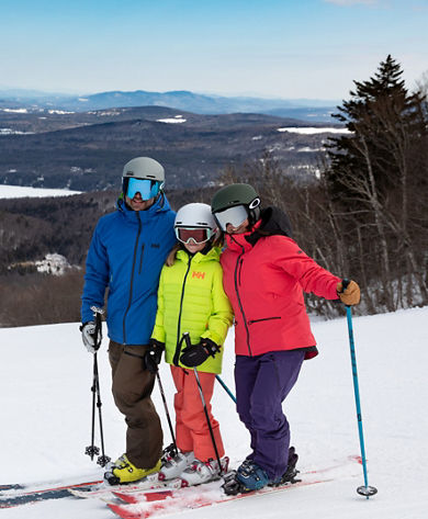Two Parents and One Child Posing with View of Lake  at Mount Sunapee