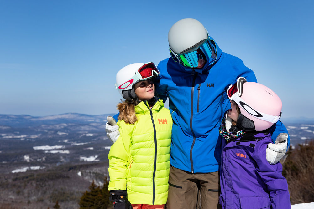 Father Hugging Two Children  at Mount Sunapee