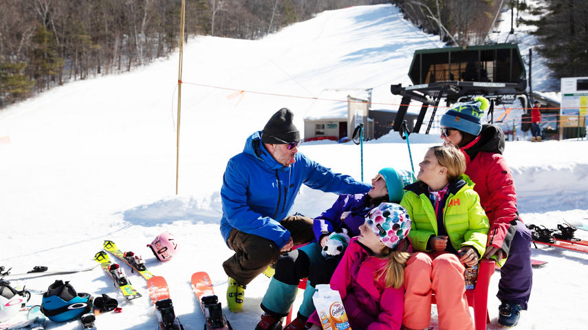 Family Having Fun and Relaxing on The Beach at Mount Sunapee
