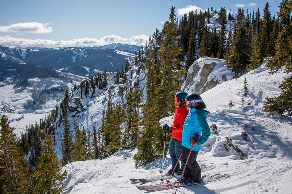 Skiers looking out over Third Bowl in Crested Butte