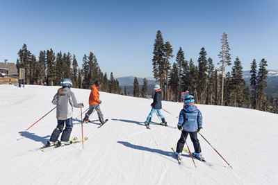 Family Skis Together on a Spring Day in Northwest Territory at Northstar California Resort