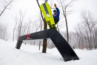 Teenage BoySnowboarder Hits Rail at Carinthia Terrain Park at Mount Snow