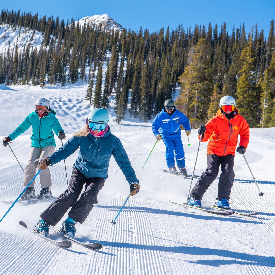 Adult ski lesson with peak in background at Crested Butte