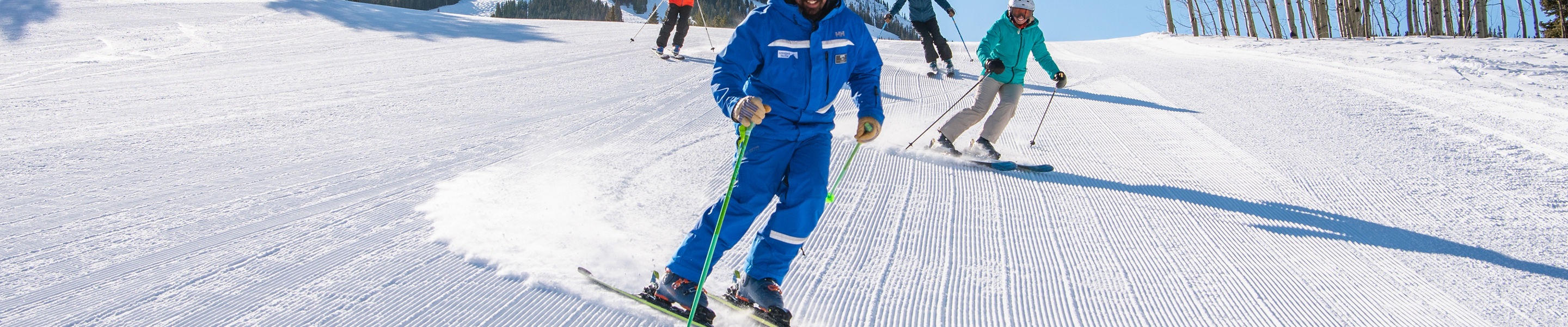Adult ski group with peak in background at Crested Butte