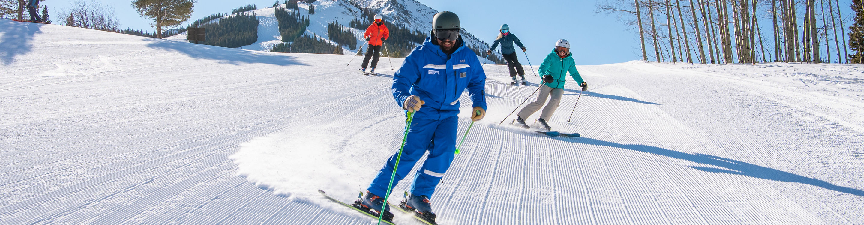 Adult ski group with peak in background at Crested Butte