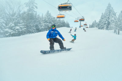 Family Following Instructor Down Trail Under Sunburst Six at Okemo