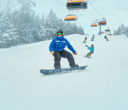 Family Following Instructor Down Trail Under Sunburst Six at Okemo