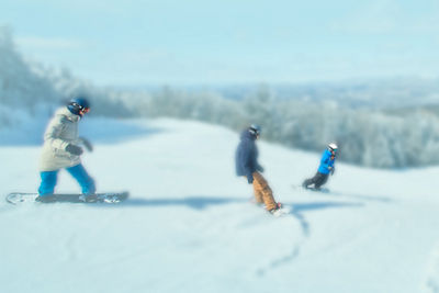 snowboarders carving down the mountain
