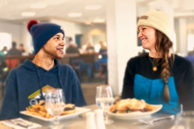 Husband and Wife Sharing Meal and Smiling at Okemo