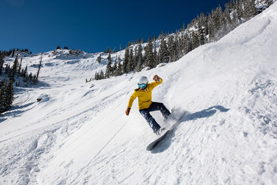 Snowboarder coming out of powder turn in Spellbound at Crested Butte