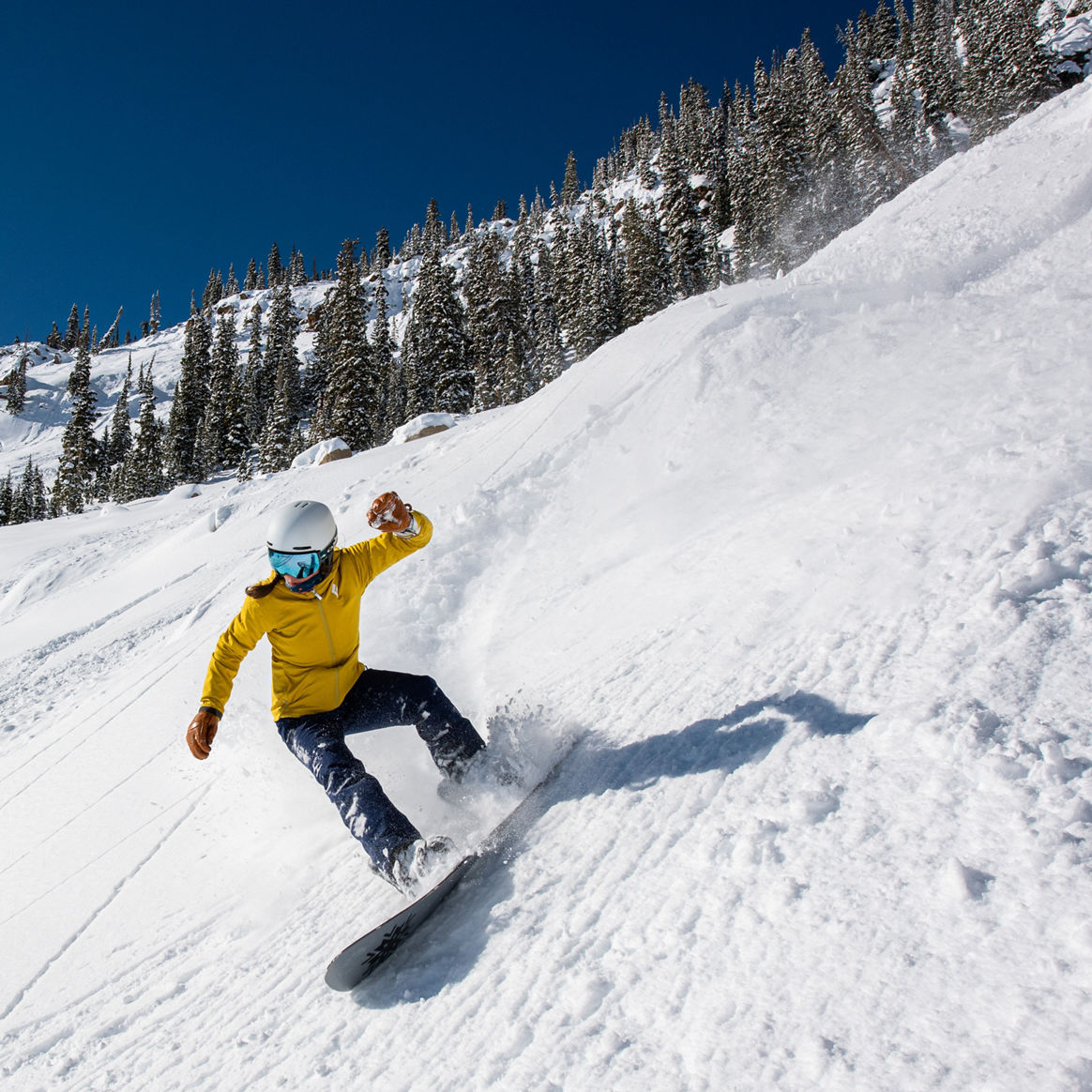 Snowboarder coming out of powder turn in Spellbound at Crested Butte