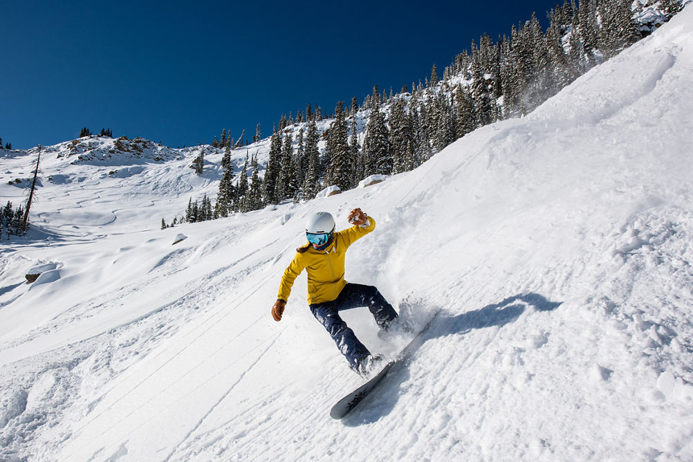 Snowboarder coming out of powder turn in Spellbound at Crested Butte