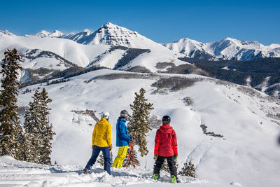 Skiers and snowboarders looking at Teocalli Mountain from Crested Butte