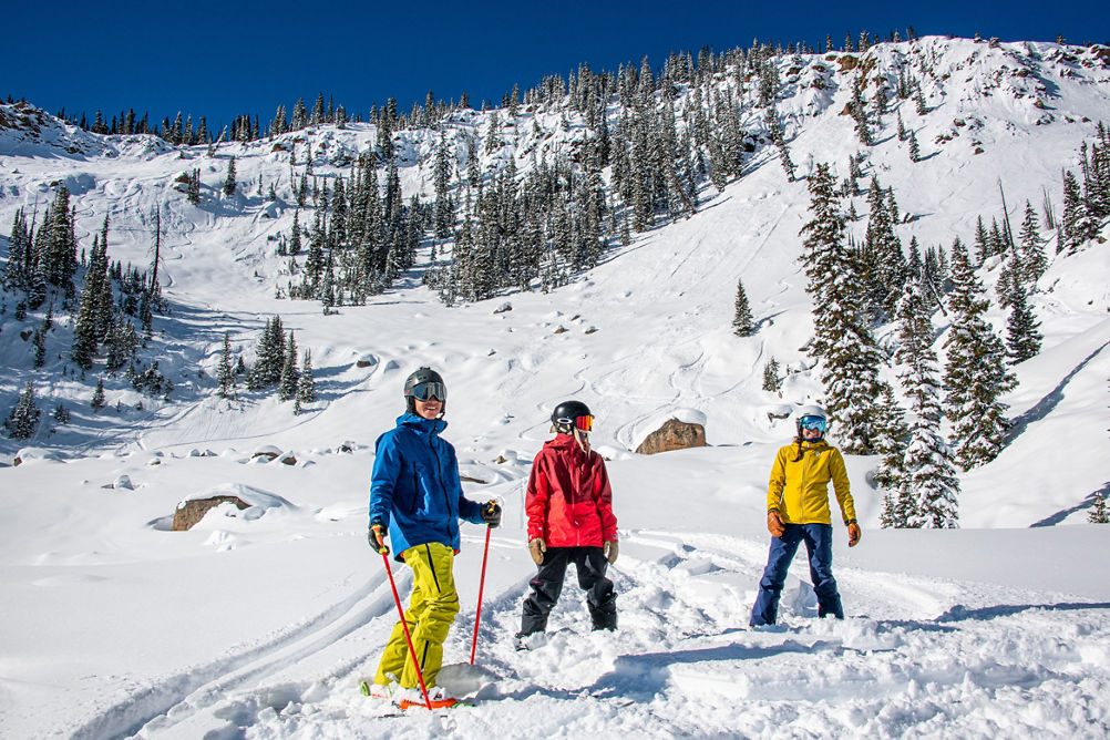Group smiling after skiing and riding Spellbound Bowl at Crested Butte