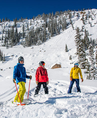 Group smiling after skiing and riding Spellbound Bowl at Crested Butte