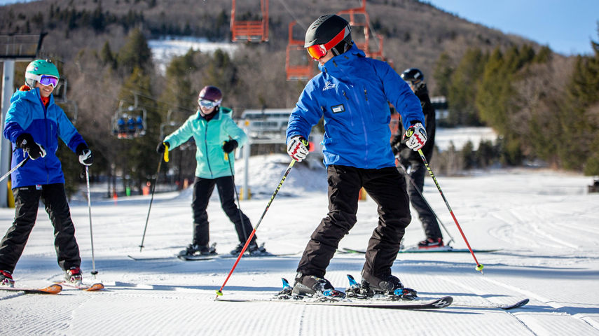 Skiers Follow Ski Instructor Down Hill at Hunter Mountain
