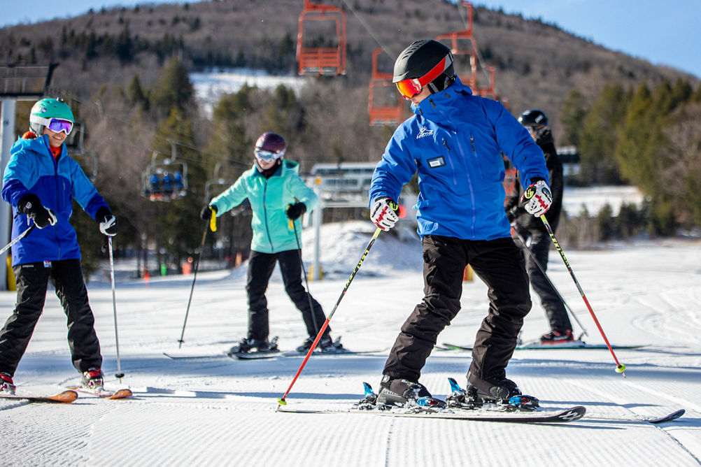 Skiers Follow Ski Instructor Down Hill at Hunter Mountain