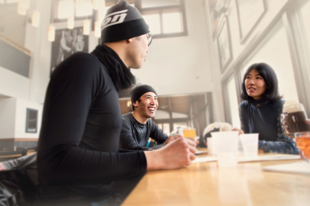 Group of Friends Talking and Laughing Indoors in Okemo