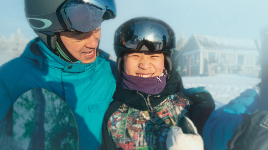 Father and Son Smiling in Snowboard Gear at Okemo
