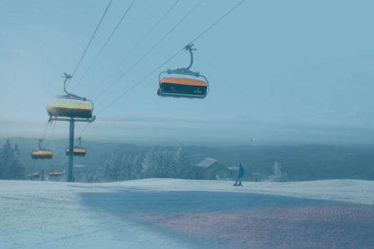 Snowboarder Riding Underneath Sunburst Six  in Okemo