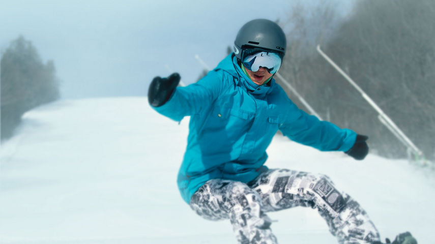 Man Turning Heelside on Snowboard on Wide Trail at Okemo