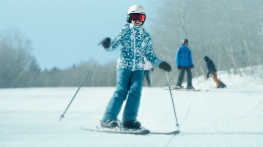 Child Skiing Down Hill and Smiling in Okemo