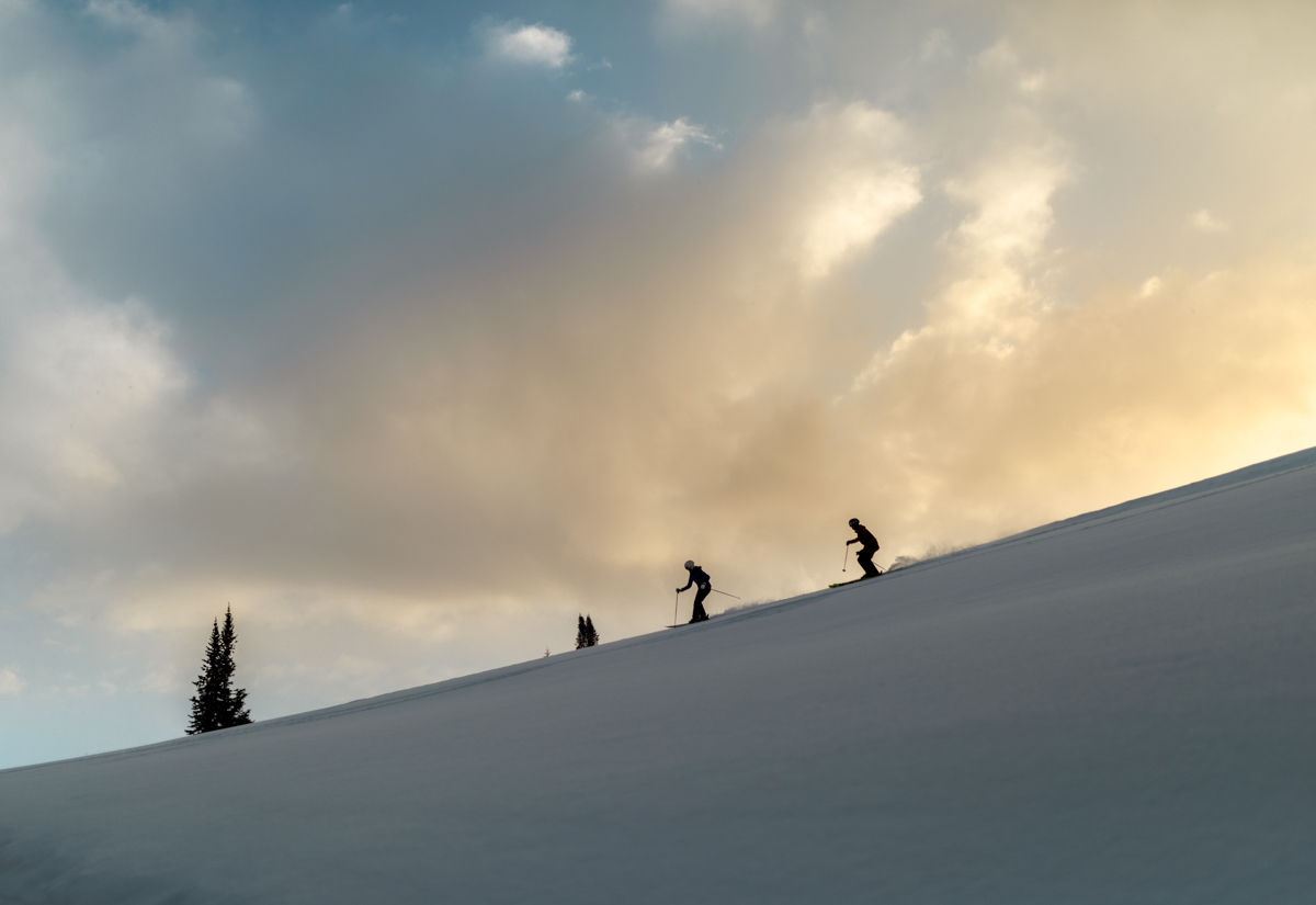 Couple skiing at sunrise