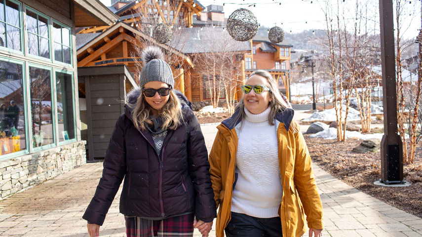 Female couple walking at Spruce Village