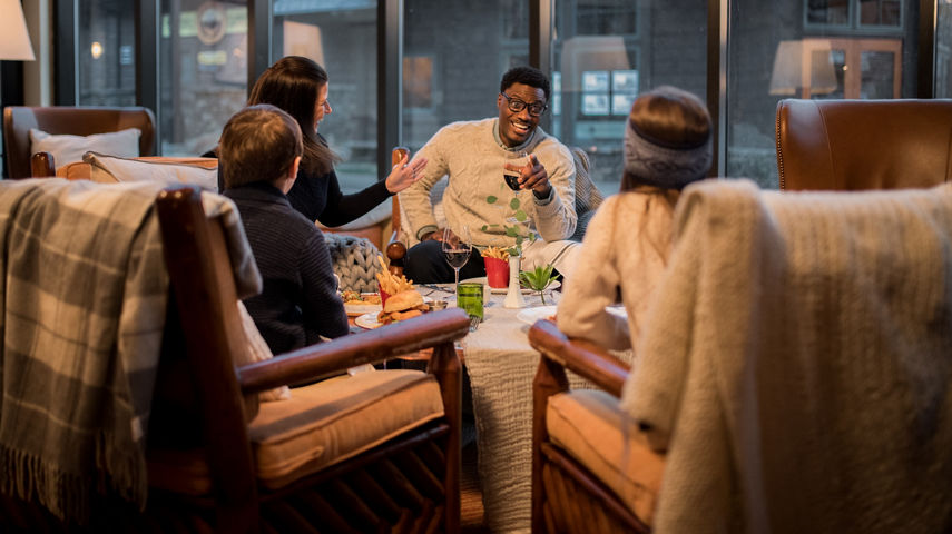 Family Having Food Inside Stowe Mountain Lodge at Stowe