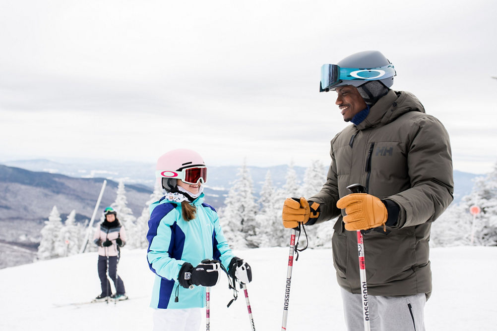 Father and Daughter Talking on Slope, Mom in Background at Stowe