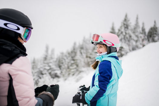Daughter Smiling at Mom on Slope at Stowe