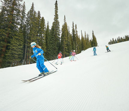Youth ski group skiing with instructor at Keystone Resort