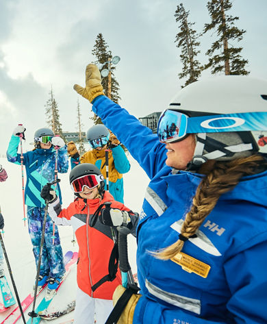 Instructor and ski group high fiving at Keystone Resort
