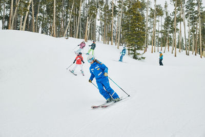 Instructor and child ski group in trees at Keystone Resort
