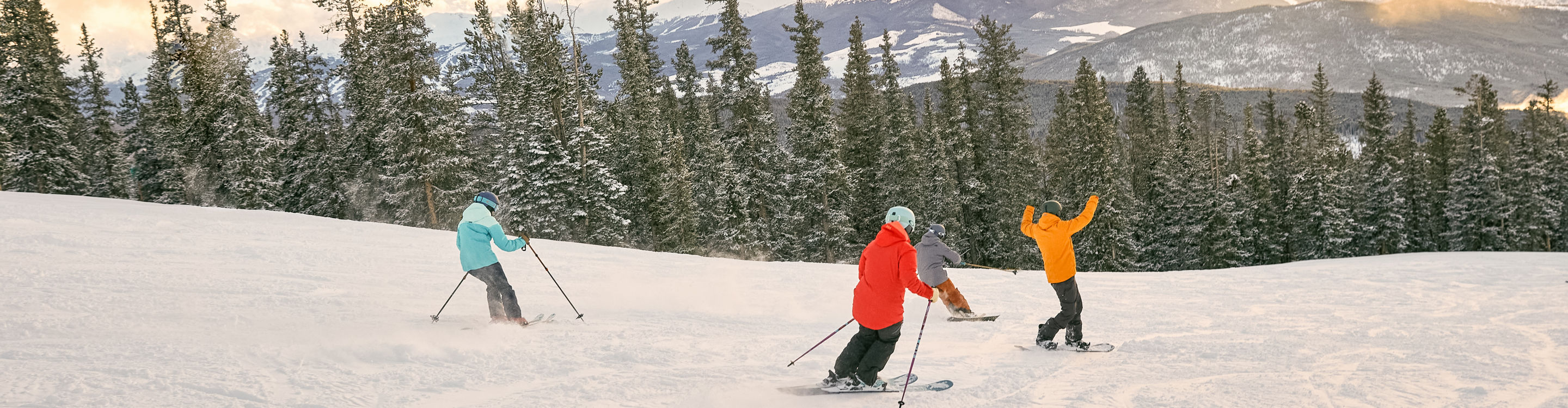Group rides down Keystone Resort during sunset 
