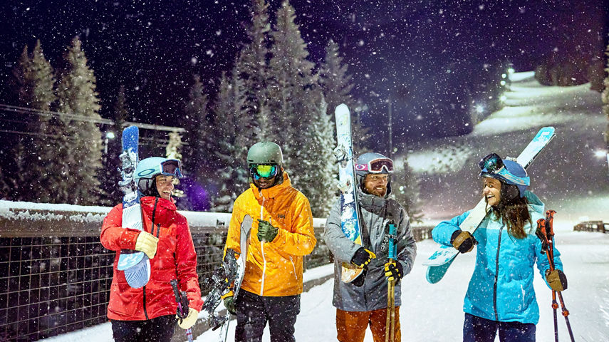 Friend group walking under the lights night skiing at Keystone Resort