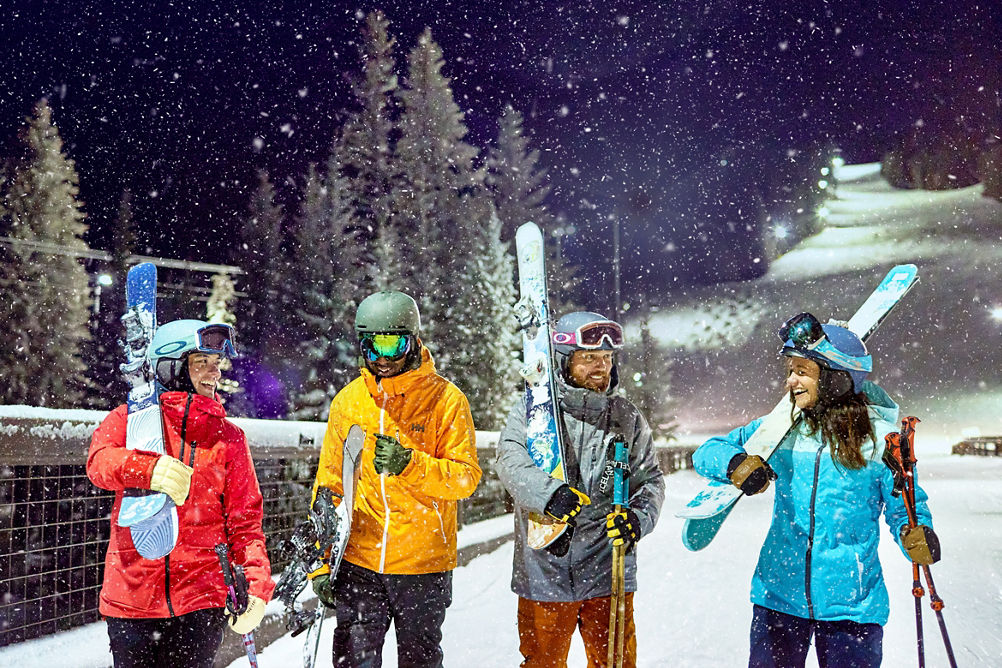 Friend group walking under the lights night skiing at Keystone Resort