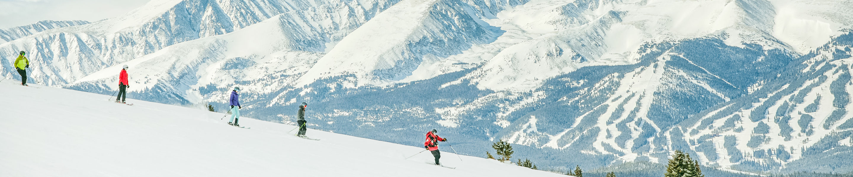 Group riding with epic mountain backdrop after cat ride at Keystone Resort