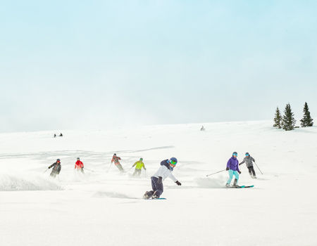 Group riding fresh snow after cat skiing at Keystone Resort